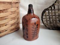 Redware Bottle and Stopper with Black Floral Motif and Square Bottom