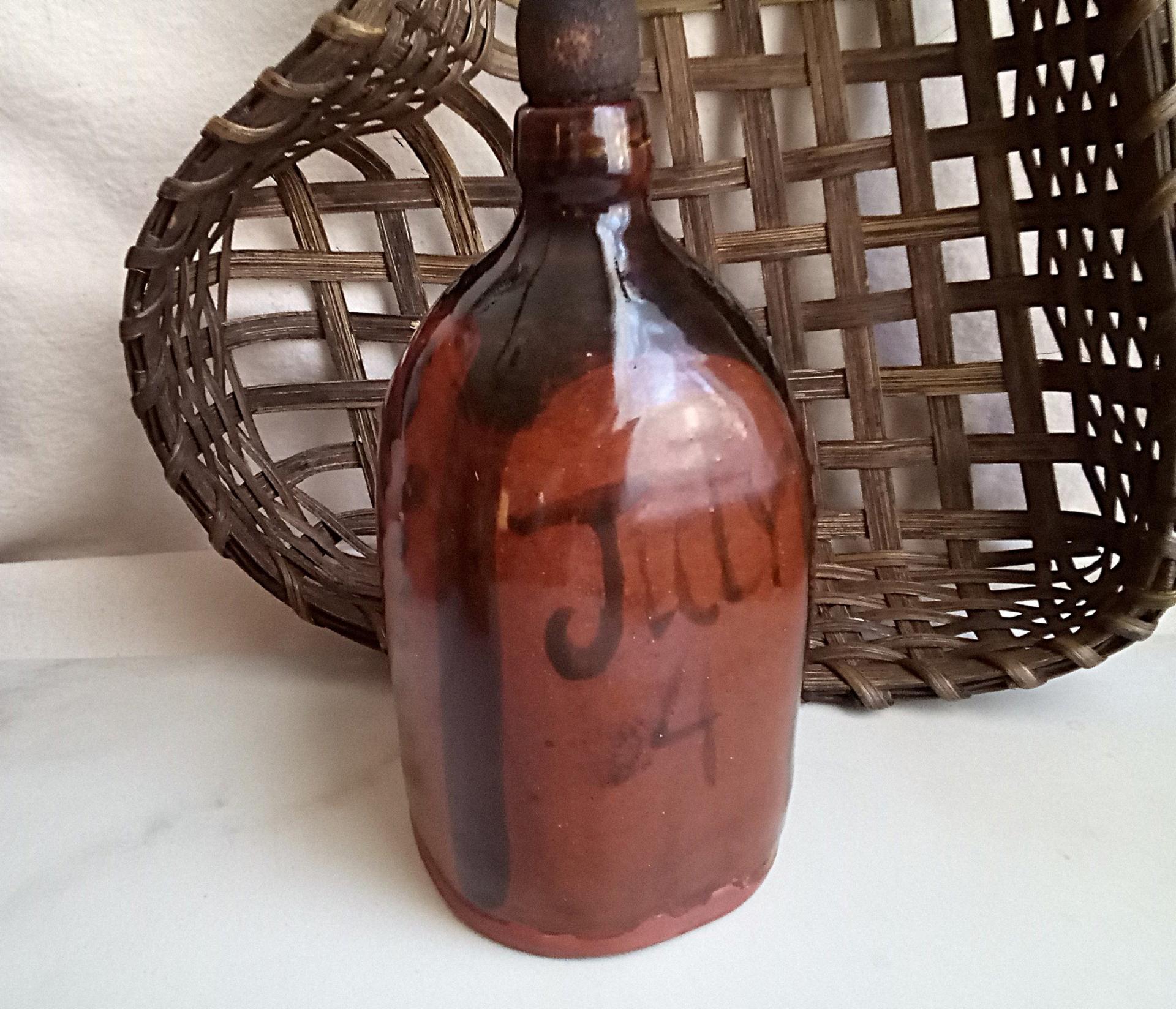 Redware Bottle and Stopper with Black Motif and Square Bottom