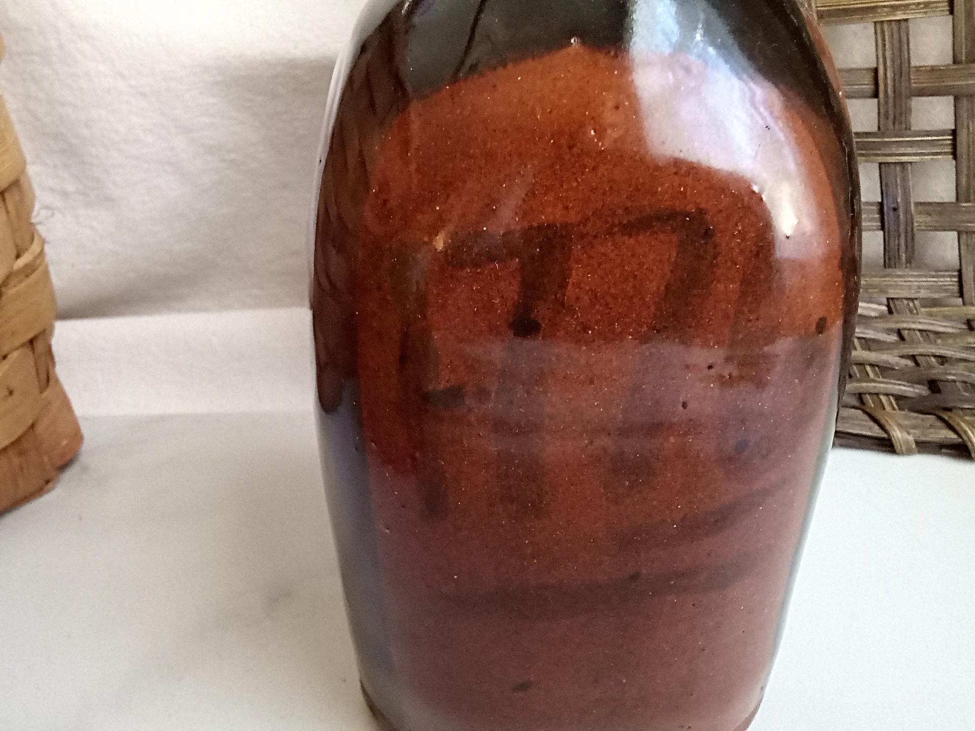 Redware Bottle and Stopper with Black Motif and Square Bottom